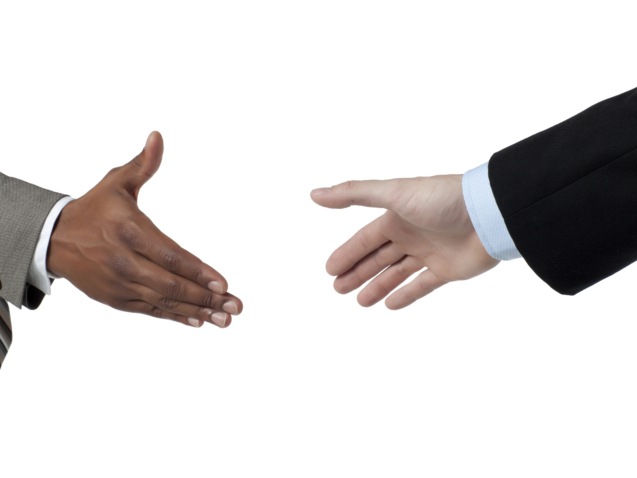 Two business people about to hand shake isolated on a white surface