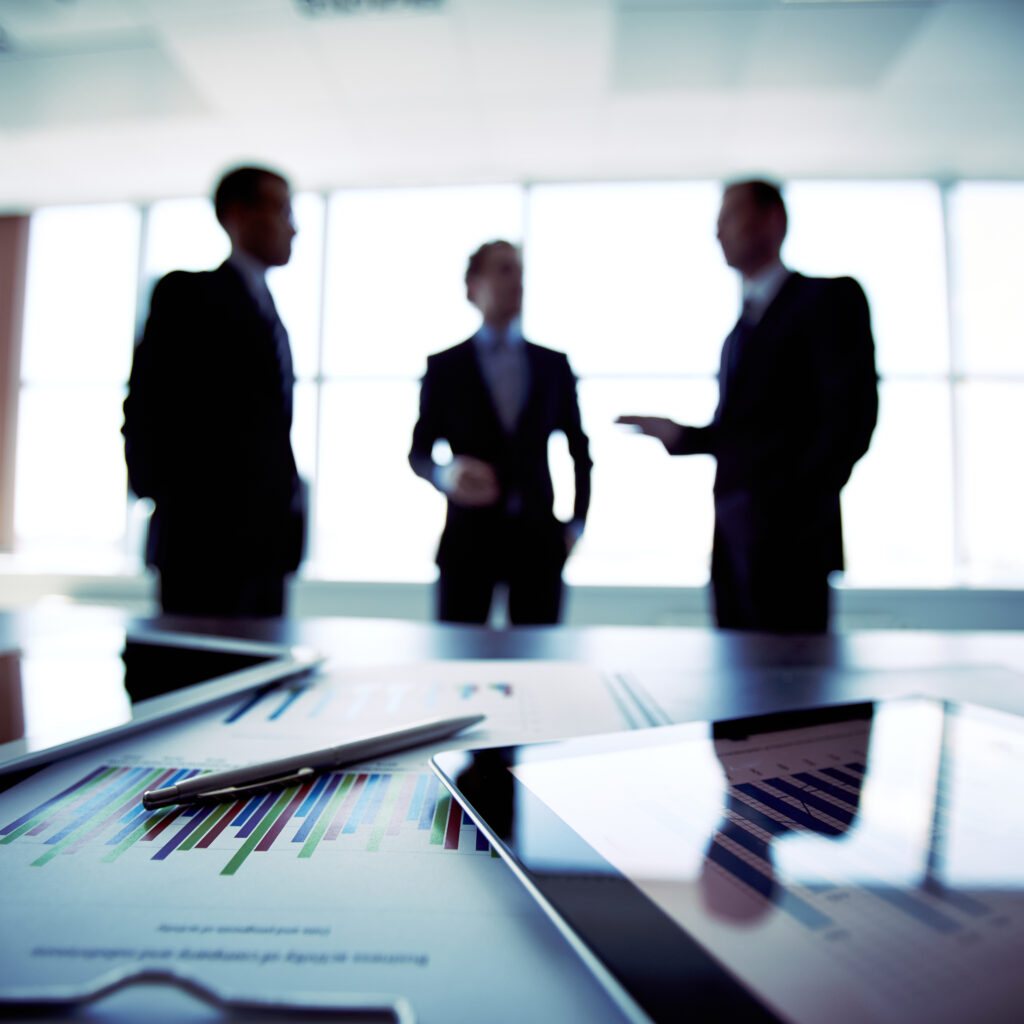 Colleagues meeting to discuss their future financial plans, only silhouettes being viewed