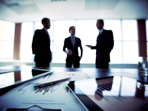 Colleagues meeting to discuss their future financial plans, only silhouettes being viewed