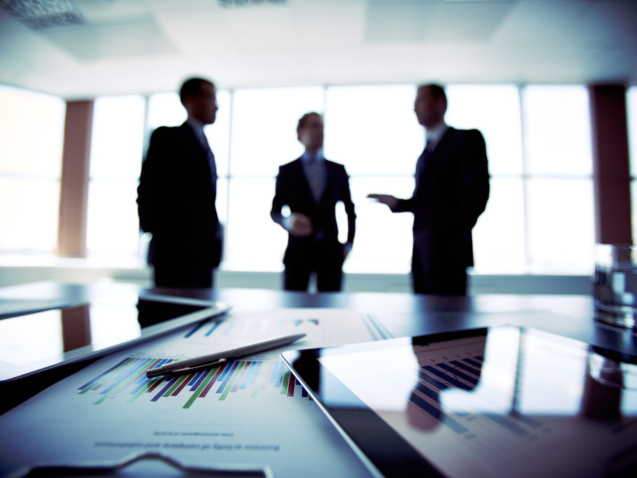 Colleagues meeting to discuss their future financial plans, only silhouettes being viewed